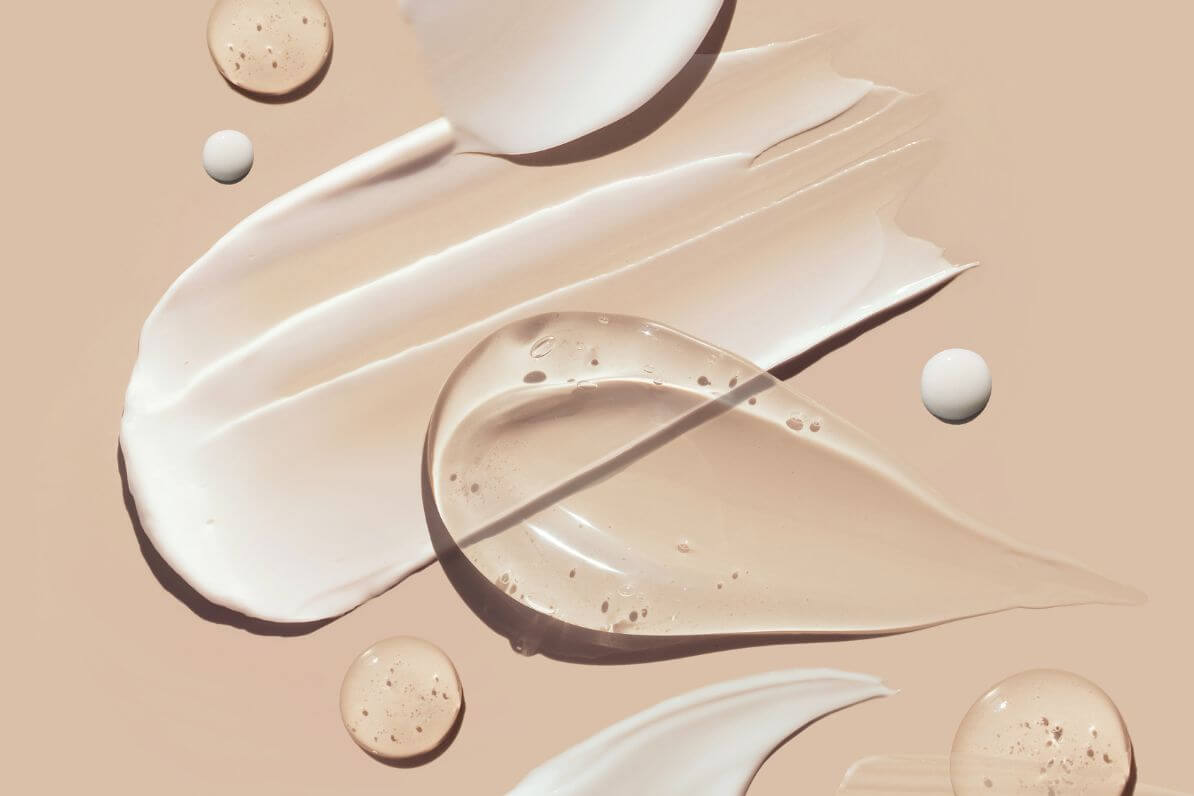 smears of ZO skin creams on a beige background